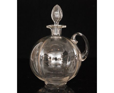 An early 20th Century Stourbridge clear crystal glass spirit decanter of swollen ovoid form with fluted body, applied loop ha