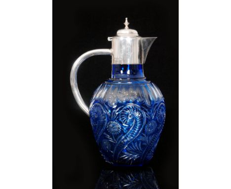 A late 19th Century Stevens & Williams claret jug of ovoid form, cased in blue over clear crystal and polished intaglio cut w