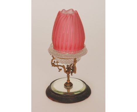 A late 19th Century Stourbridge glass night light with a quilted satin dome in cranberry mounted to a Clarkes Patent pressed 