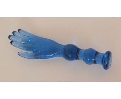 A 19th Century novelty blue glass pipe tamper in the form of a hand above a double knopped stem, length 9cm. 