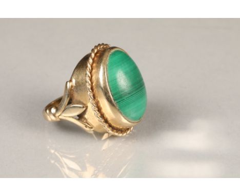 Unmarked yellow metal ring, set with an oval malachite cabochonTotal weight 14g, ring size K/L