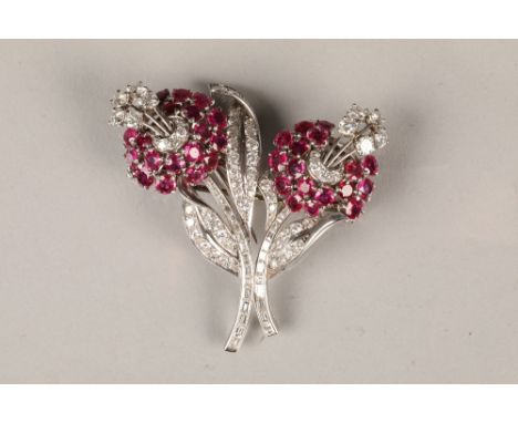 Ruby and diamond floral double clip brooch, comprising of two ruby flower heads, claw set with eighteen and seventeen round f