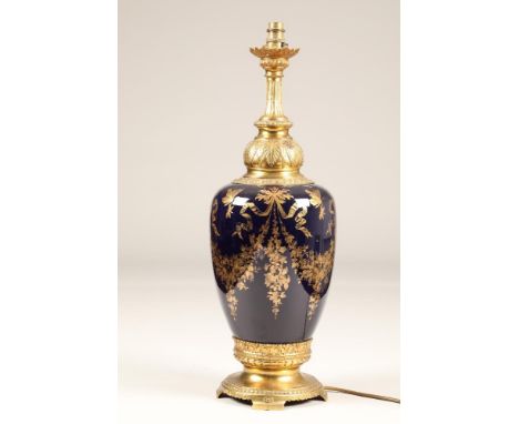 Large porcelain table lamp, gilt metal base and neck, decorated with gilt floral swags and tailsHeight 63cm