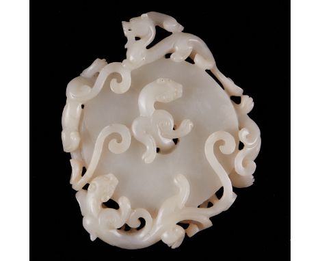 Carved white jade bi with four encircling dragons carved in high relief. A fifth dragon slides through the central hole to pe