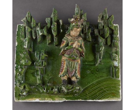 Chinese Ming dynasty ceramic figural architectural temple tile in high relief glazed with a green glaze background and yellow