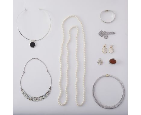 Group of sterling silver jewelry. Includes three silver necklaces, one silver bracelet, one pair of earrings, and three penda
