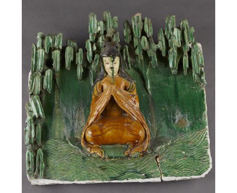 Chinese Ming dynasty ceramic figural architectural temple tile in high relief glazed with a green glaze background and yellow