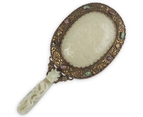 20th century Chinese jade and silver hand mirror decorated with low relief motifs of bats, fish, shells, and flowers and appl