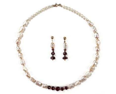 One pair of mid-twentieth century garnet and baroque pearl dangle friction back earrings in 14 karat yellow gold along with a