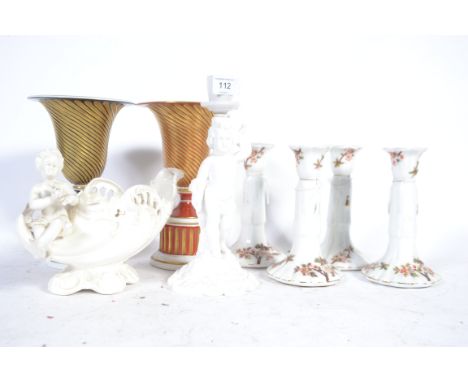 A Copeland and Spode cherub candle stick along with porcelain candle stick pairs