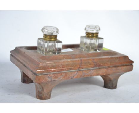 An early 20th Century glass and marble twin inkwell