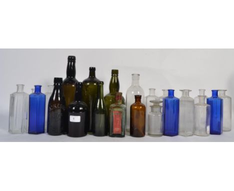An assortment of vintage glass bottles to include Bristol blue examples, green glass and some hexagonal examples etc.