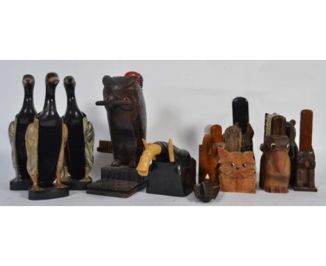 A collection of vintage animal clothes brushes holders to include three bakelite 1950s duck examples along with carved wooden
