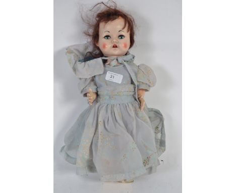 A vintage 1950s Pedigree toy doll in original vintage dress