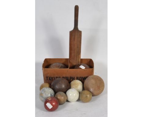 A collection of vintage sporting balls to include shot put , bowls , solid wooden examples and various others