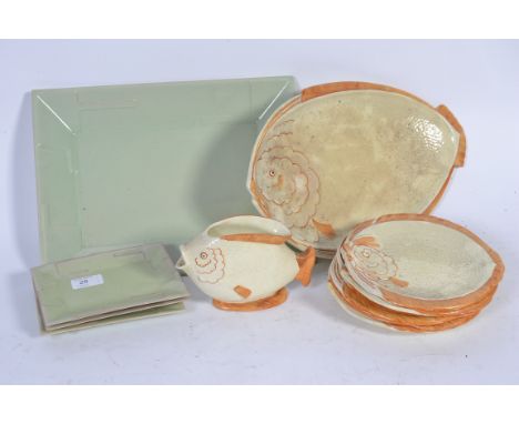 A collection of fish plates of varying sizes along with a matching pouring jug accompanied by a set of vintage serving plates