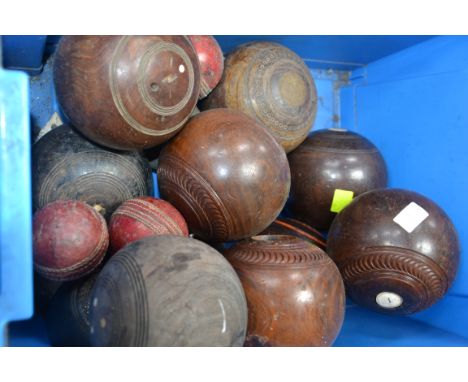 A good collection of vintage bowls mostly wooden along with a group of vintage cricket balls