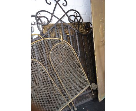 A brass fire screen depicting a sailing boat along with a group of other brass screens