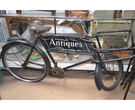 A vintage mid 20th century butchers bike with framework for a basket, with advertising panel for B & C Craic Antiques St Marg
