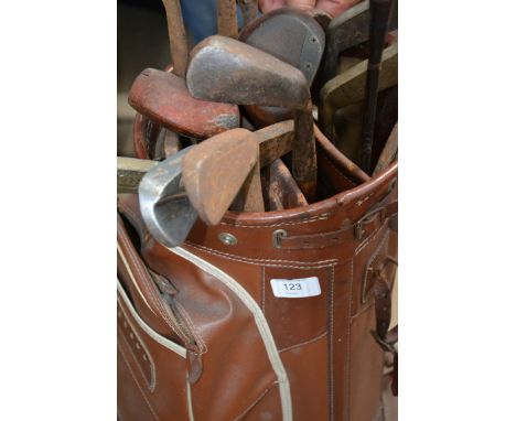 A collection of 20th Century golf clubs held within a vintage golfing bag