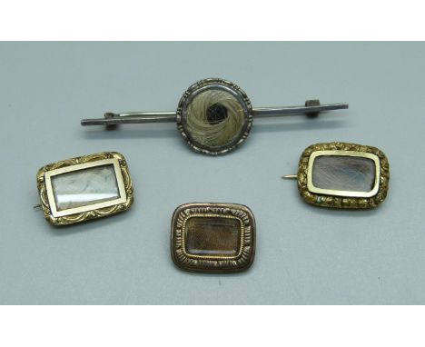 Three small mourning brooches and a silver mourning brooch 