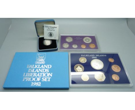 A silver proof £1 coin, a 1977 Royal Australia mint proof coin set and a 1982 Falkland Islands Liberation proof set 