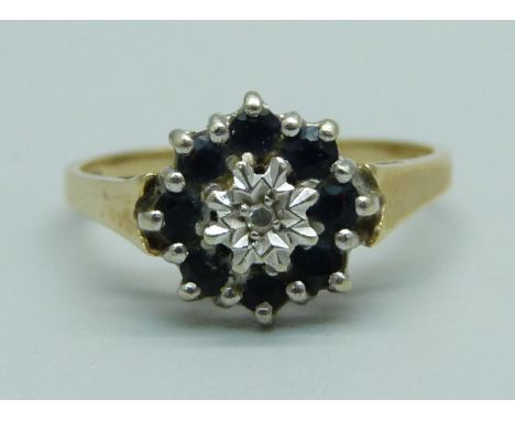 A 9ct gold ring set with a diamond and sapphires, 1.8g, M 