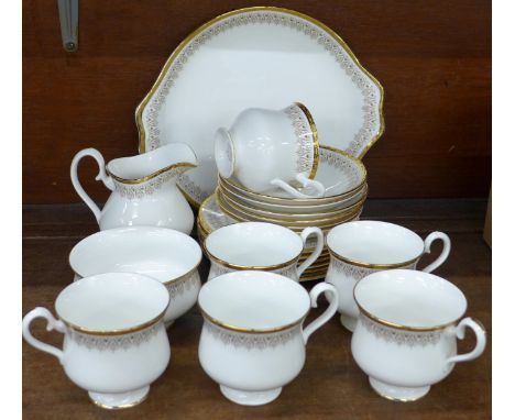 A Royal Doulton Burlington pattern six setting tea service, six cups, saucers and side plates, cake plate, cream and sugar 