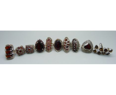 Ten large 'chunky' silver and garnet rings, 128.01g 