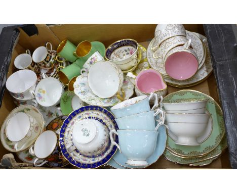 A large collection of English porcelain cups and saucers including Minton, Davenport, Royal Doulton, Royal Chelsea, Lynton, W