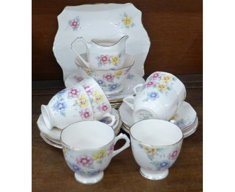 A Tuscan China Plant six setting tea service, six cups, saucers, side plates, a cake plate, sugar and cream, one cup with chi