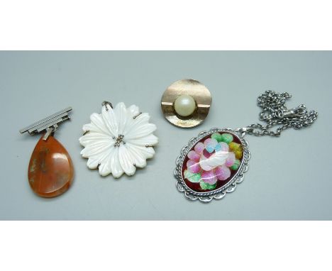 Two silver and silver mounted pendants and two similar brooches 