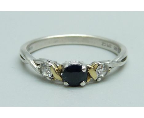 A silver ring with 9ct gold detail and set with three stones, N 