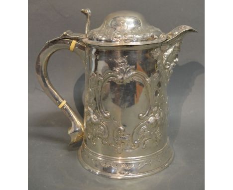 A George III Irish Silver Large Flagon, embossed with scrolls amongst foliage and with mask head spout and shaped handle, Dub