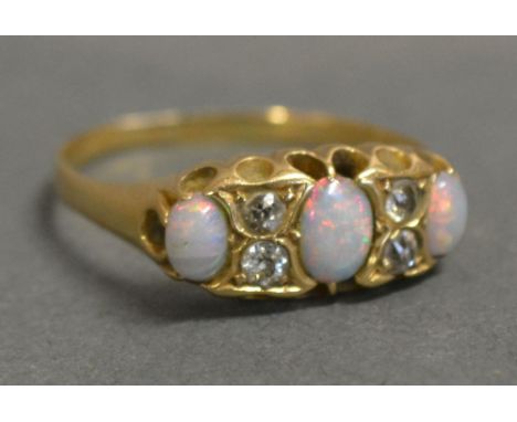 An 18ct. Yellow Gold Opal and Diamond Ring, set with three opals and four diamonds