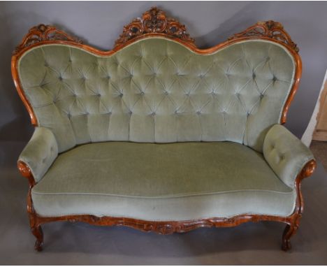 A Victorian Walnut Double Spoon Serpentine Drawing Room Sofa, the pierced and button upholstered back above a stuff over seat