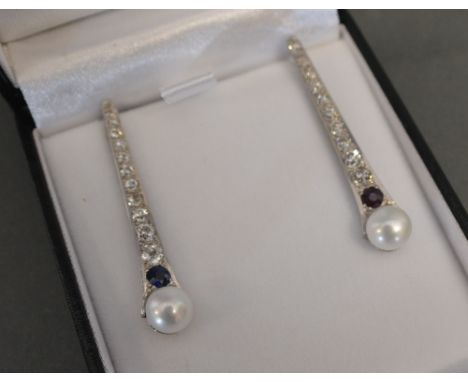 A Pair of White Gold Diamond and Pearl Drop Earrings, one set with a sapphire, the other with a ruby