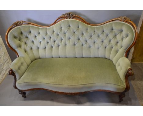 A Victorian Carved Walnut Serpentine Double Spoon Back Sofa, the pierced carved and button upholstered back above a stuff ove