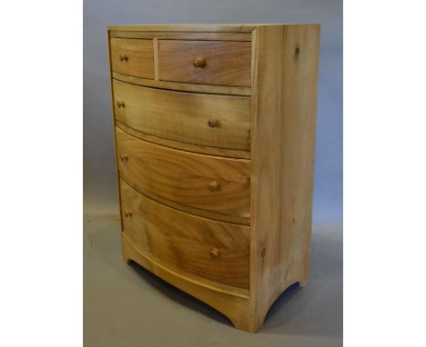 A Hardwood Bow Fronted Chest of two short and three long drawers with knob handles, 59 cms wide