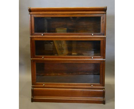 A Globe Wernicke Mahogany Three Section Bookcase, with three glazed sections above a shaped plinth