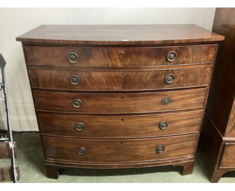 A large mahogany bow front chest of 4 long graduated drawers, the top two drawers combined as one, some splits and handle los