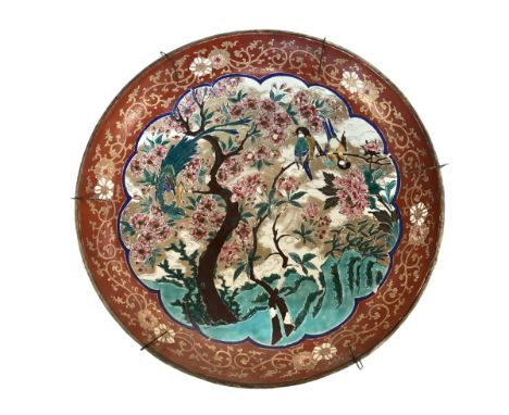 A large Japanese charger, 37.5cm diameter, decorated trees and birds, and verso rim with foliage, as found with some wear, an
