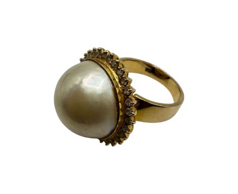 An 850 marked .pearl and diamond dress ring. Central button pearl with a surround of single cut diamonds. Size m. 11.6g. 
