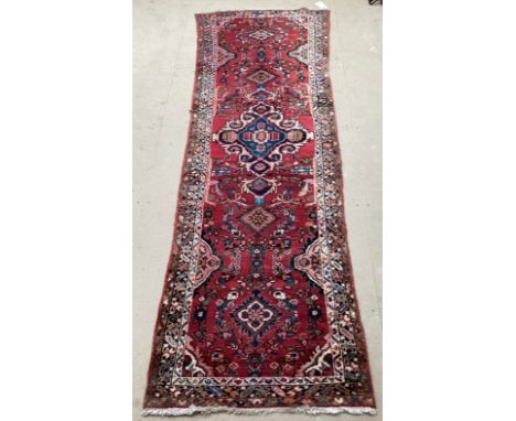 Red ground runner, see photos for details, 96 cm x 297 cm, condition all over wear.