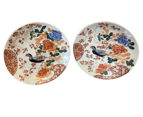 A pair of Oriental chargers, Japanese Kutani style, decorated in the Imari palette, exotic birds and foliage, 31cm diameter, 