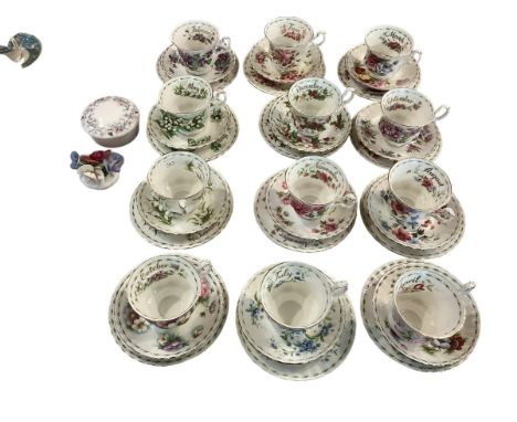 A set of Royal Albert Bone china cups, saucers and plates, illustrated with a month for each set