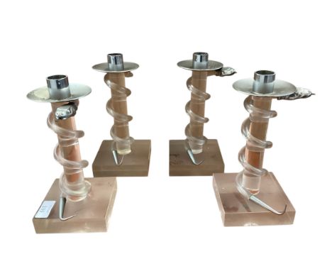 Four Allesandro Albrizzi candlesticks, approx 21cm high overall, in used condition, one candlestick is missing snake head