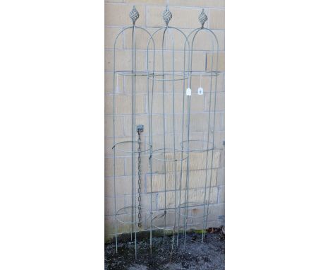 A set of three light grey wrought-iron garden obelisks, each with a spiral-twist finial, 69¼” high.