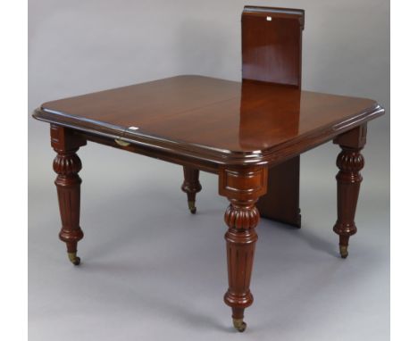 A Victorian-style mahogany extending dining table, with moulded edge &amp; rounded corners to the rectangular top, with centr