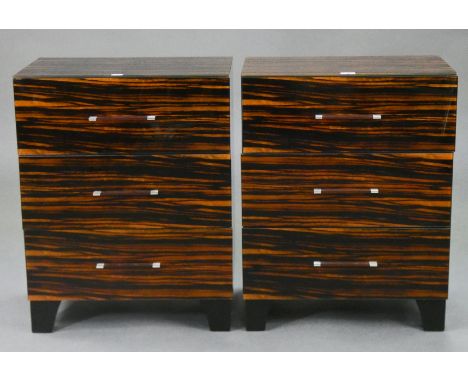 A PAIR OF R.V. ASTLEY ‘MAGLASSA’ MACASSAR EBONY VENEERED THREE-DRAWER BEDSIDE CHESTS with glass top &amp; sides, on bracket f